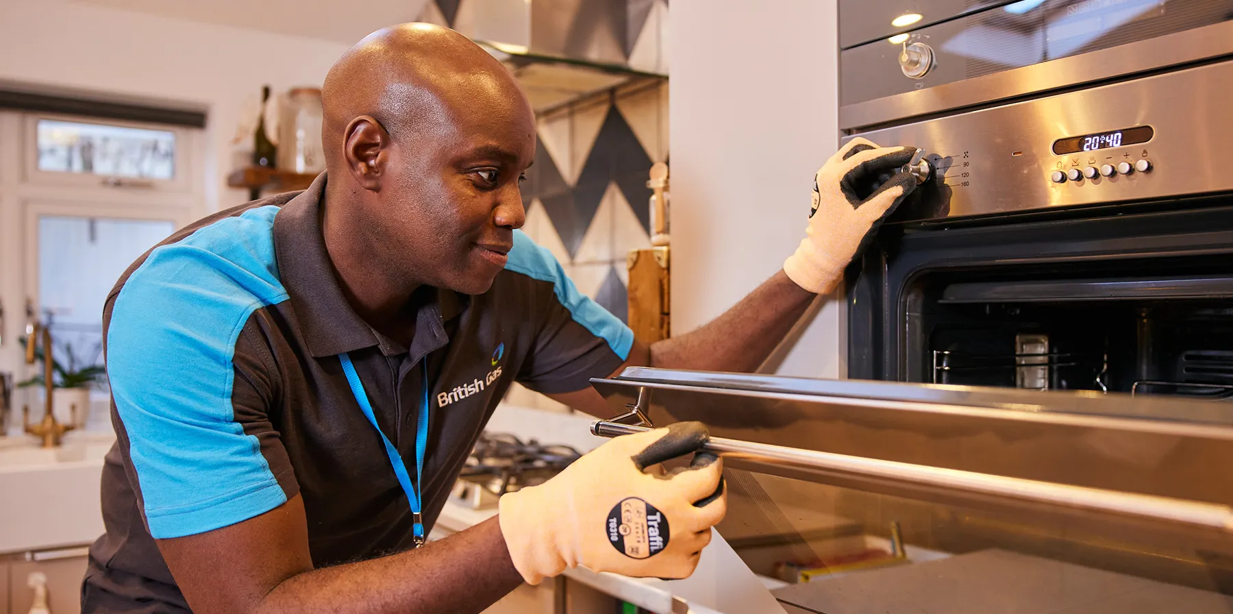 British gas engineer looking at a gas hob