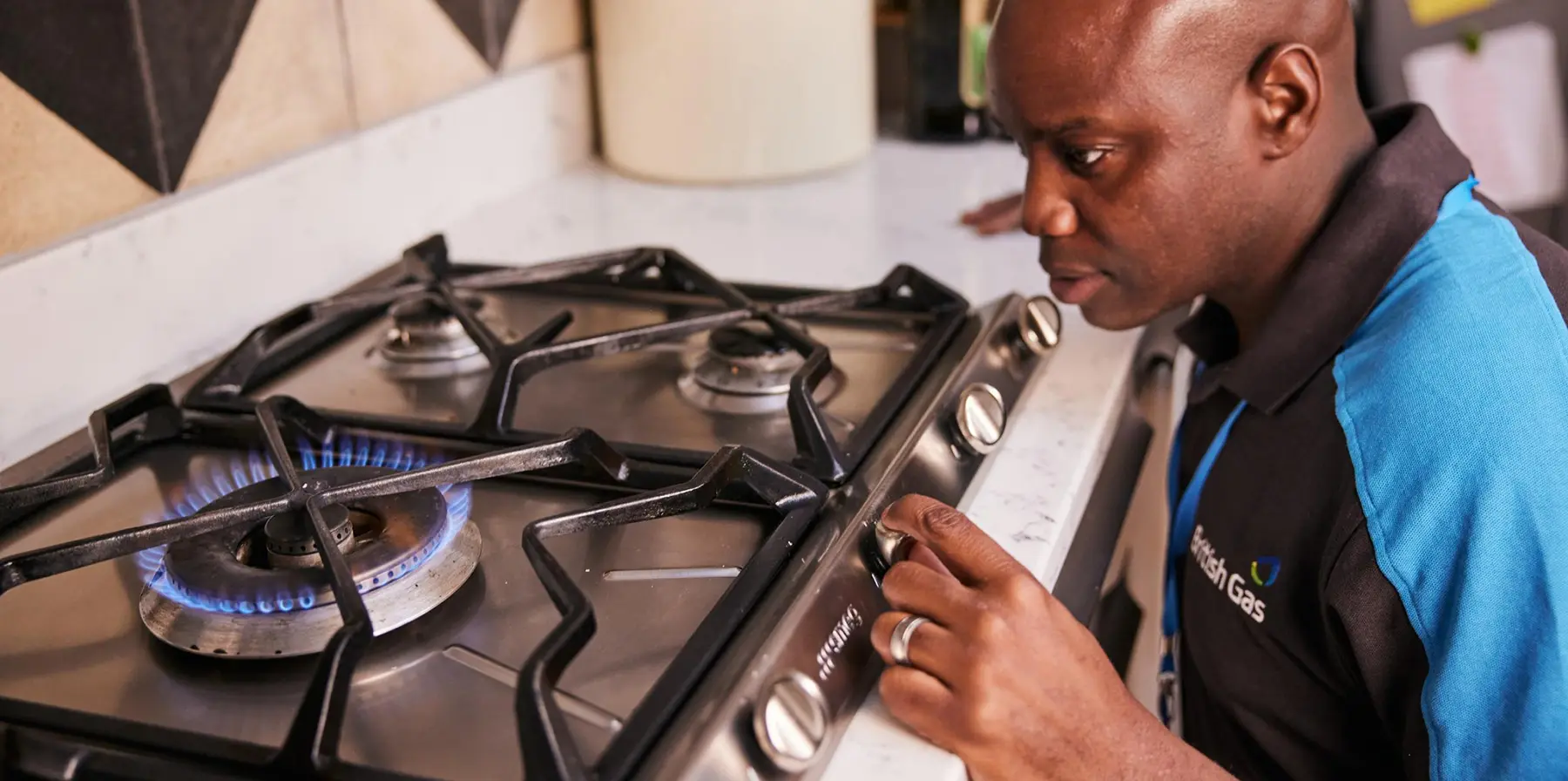 British gas engineer looking at a gas hob