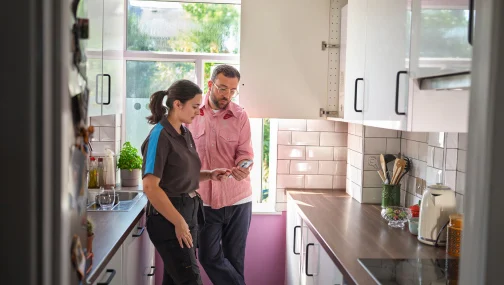 British gas engineer in the kitchen with a customer